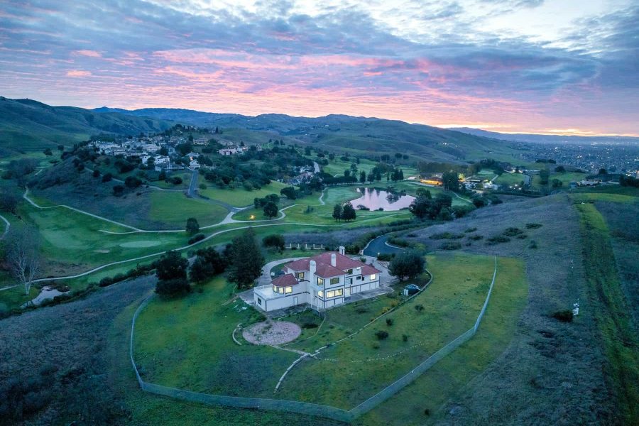 Aerial photo of an estate on a golf course at sunset